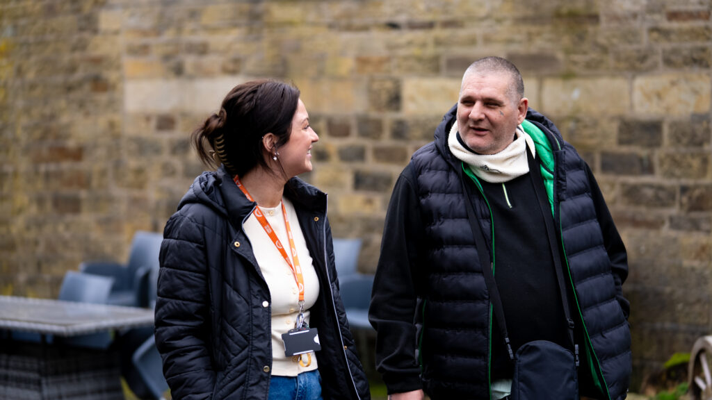 Client and staff member walking together